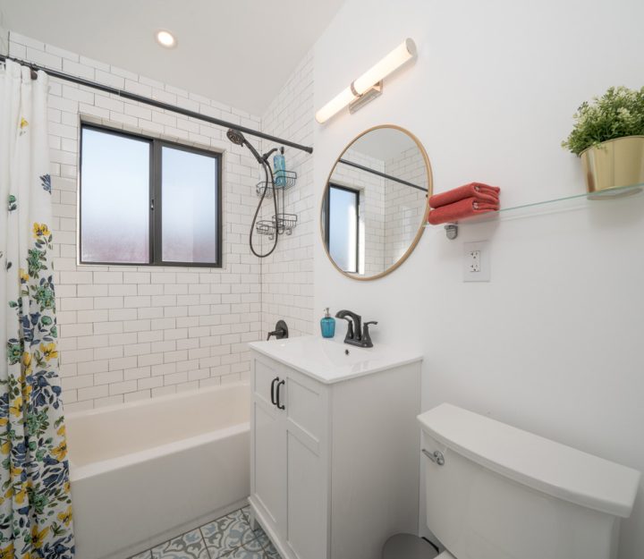 modern interior of a bathroom with shower, sink, toilet and bath tub design