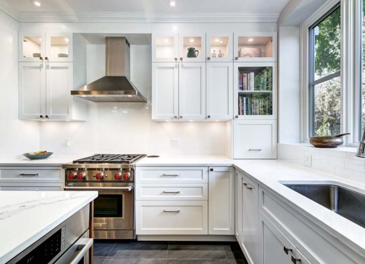 color white inspired L-shaped kitchen with silver oven and exhaust