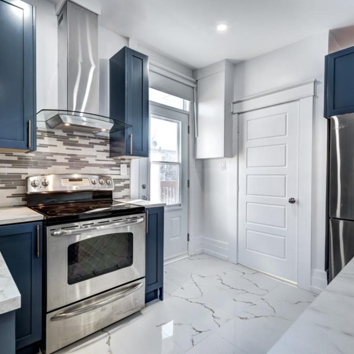blue-gray and white themed kitchen with silver appliance