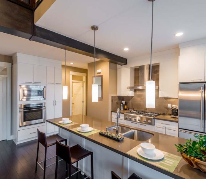 Modern, bright, clean, kitchen interior with stainless steel appliances